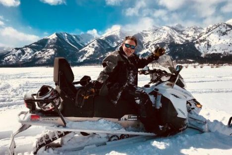 a person sitting on top of a snow covered mountain