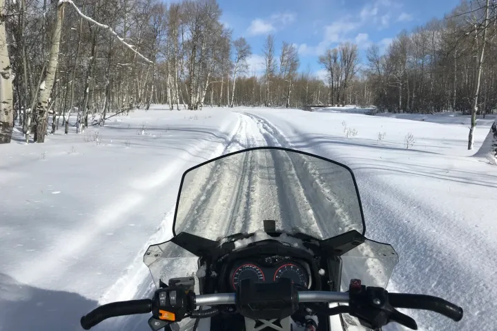 a man riding skis down a snow covered slope