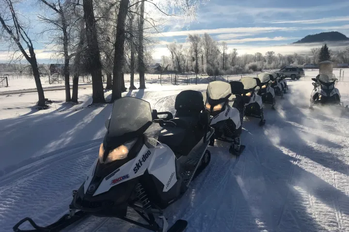 a motorcycle is parked on the side of a snow covered road