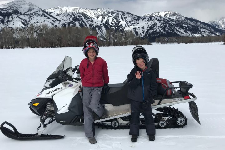 a group of people sitting in the snow