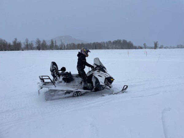 a man riding skis down a snow covered slope